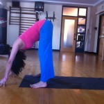 Prenatal Yoga wide legged forward bend with slight bend at the knees almost 19 weeks pregnant